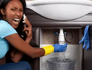 Emergency plumbing repair for a leaking sink drain under a bathroom vanity in Minneapolis, MN