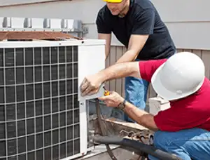 HVAC technicians repairing an outdoor AC unit on a rooftop in Minneapolis, MN