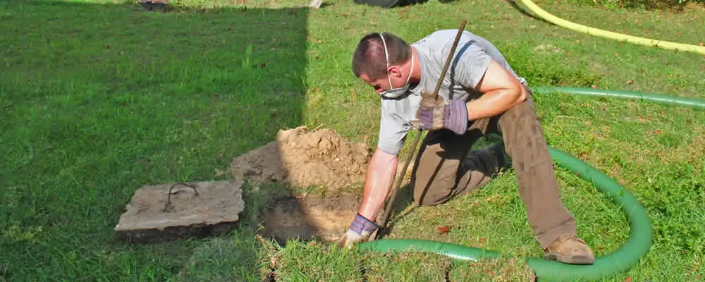 Septic pumping technician servicing a residential septic tank in Minneapolis, MN