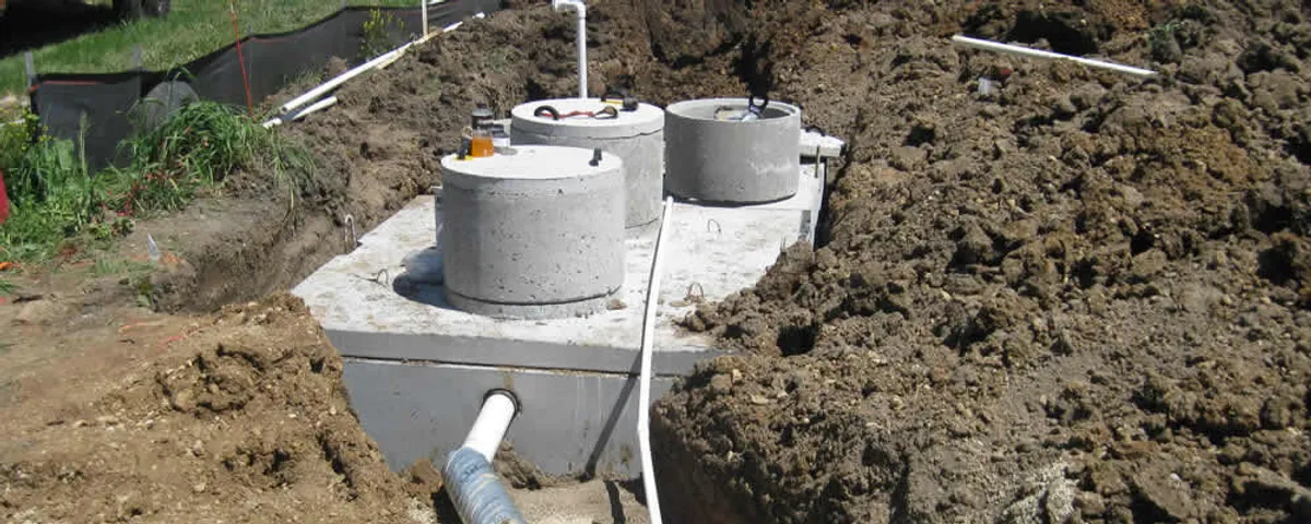 Septic system repair and installation site with tank access ports in Minneapolis, MN