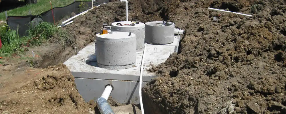 Septic system repair and installation site with tank access ports in Minneapolis, MN